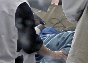 14 year old Bahia Bakari surrounded by doctors. (AP Photo/Sayyid Azim)